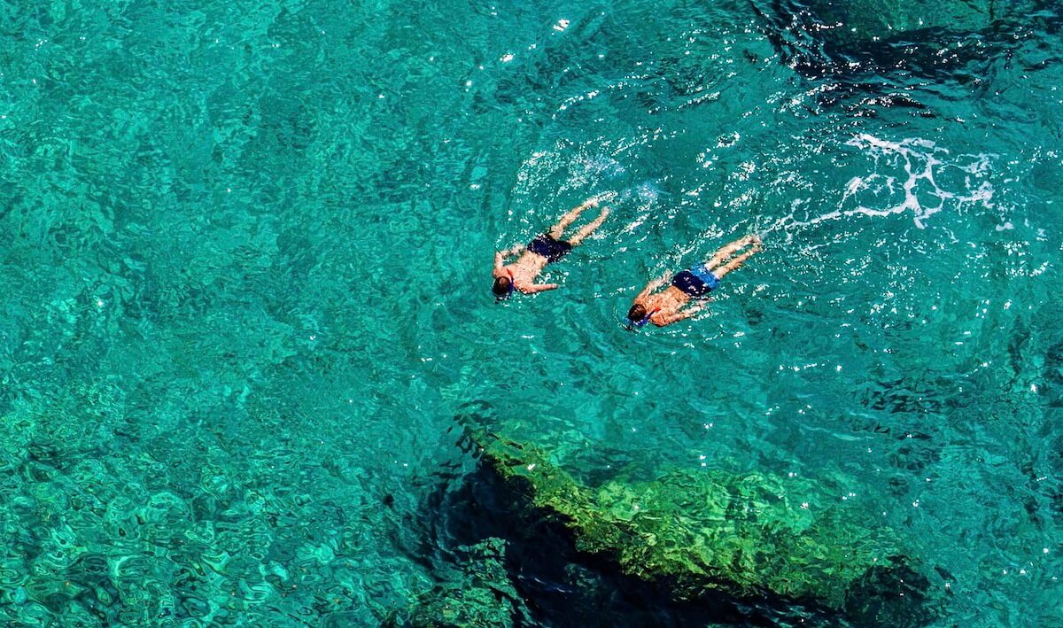 Snorkelers in crystal sea