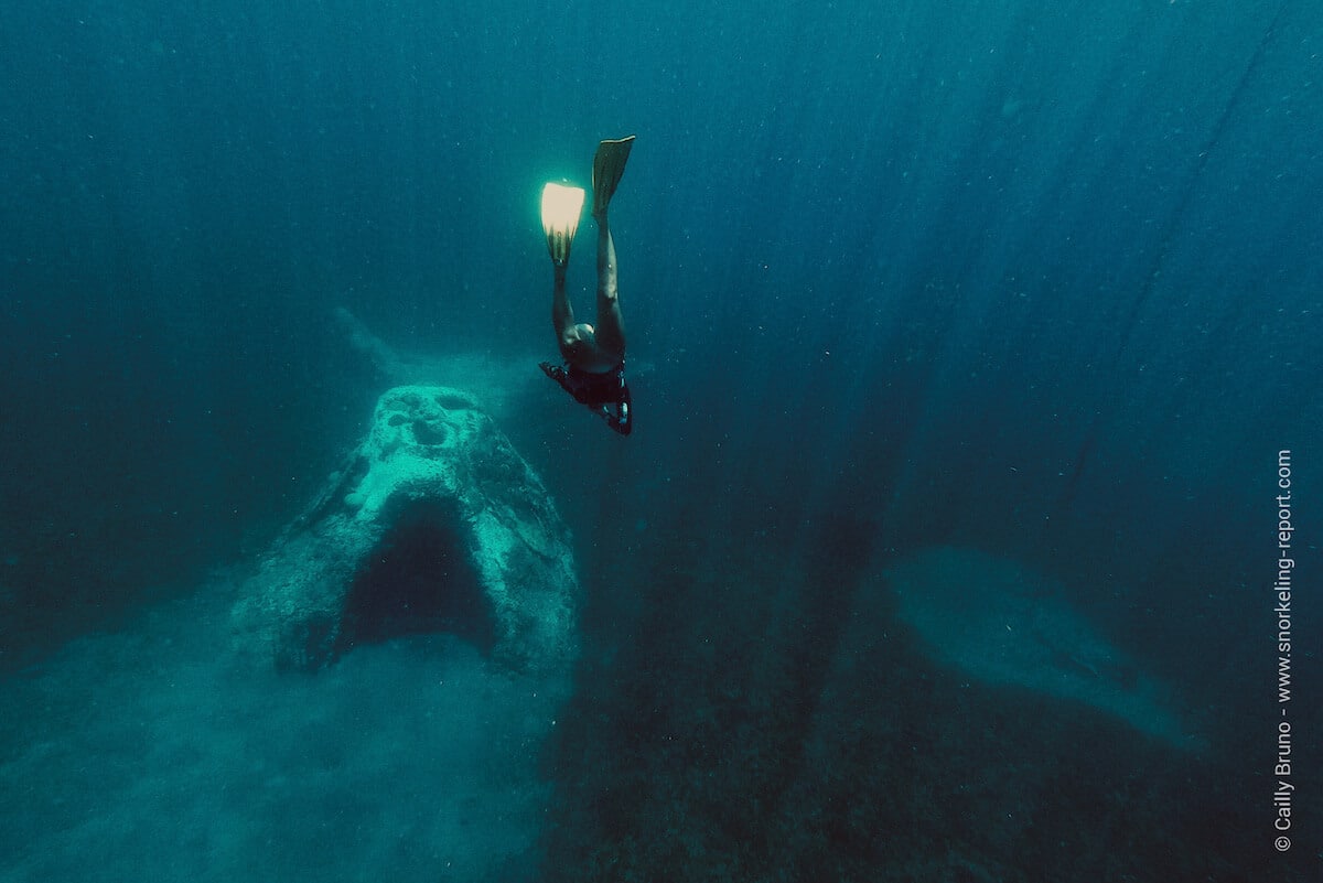 A snorkeler freedives over Manman Dlo underwater sculpture